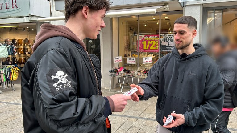 Luis Cavazzoli aus Nürtingen (rechts im Bild) verteilt nach der Entscheidung im Bundestag zur Teil-Legalisierung von Cannabis in Reutlingen Flyer für den Cannabis Social Club in Reutlingen.