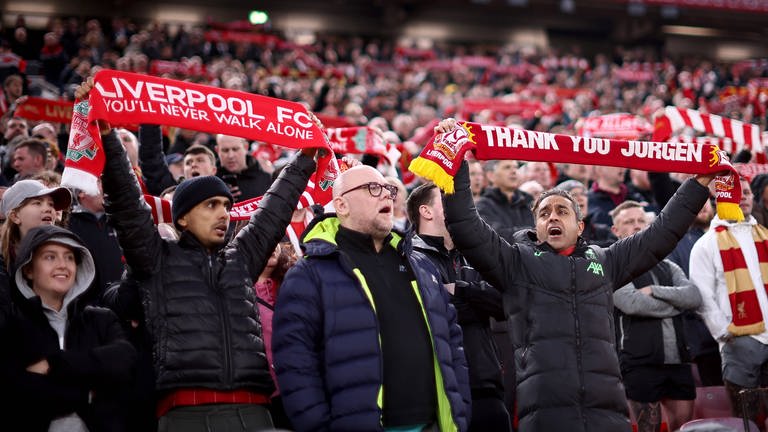 Liverpooler Fußballfans singen mit erhobenen Team-Schals (Foto: IMAGO, IMAGO / Goal Sports Images)
