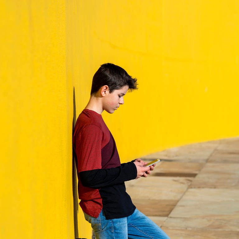 Junge mit Smartphone (Foto: IMAGO, Cavan Images)