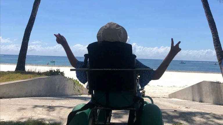 Nora Welsch bei ihrer Weltreise mit dem Rollstuhl am Strand.