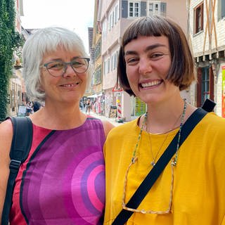 Mutter Ulli und Tochter Clara stehen in der Tübinger Fußgängerzone und lachen in die Kamera.