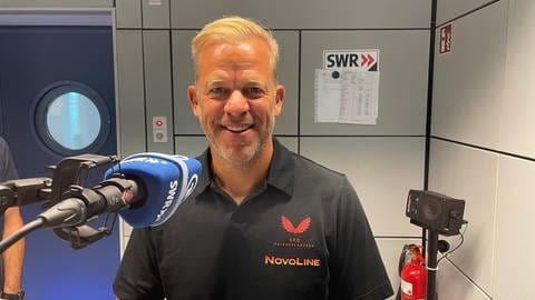 Markus Anfang steht vor dem Mikrofon im SWR Studio Kaiserslautern und beantwortet die Fragen im SWR Sport Podcast "Nur der FCK".