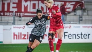 SC-Freiburg-Kapitänin Hasret Kayikci und Kölns Sharon Beck im Zweikampf.