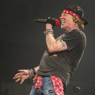 Axl Rose, Sänger der Band Guns 'n' Roses, steht auf der Bühne und singt.