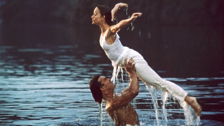 Szene aus dem Film "Dirty Dancing". Der Klassiker ist dieses Jahr in Open Air Kinos in Baden-Württemberg zu sehen. Bei SWR1 Baden-Württemberg bekommt ihr eine Übersicht über das Programm der Open Air Kinos in BW - vom Filmklassiker bis zum aktuellen Hollywood Blockbuster. Egal ob in Heilbronn, am Bodensee, in Freiburg, Stuttgart, Esslingen, Ulm oder Bad Mergentheim: Freiluft Kino an einem lauen Sommerabend ist ein ganz besonderes Erlebnis!