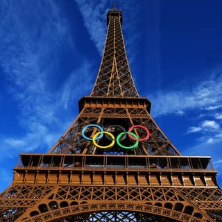 Die olympischen Ringe sind am Eiffelturm angebracht