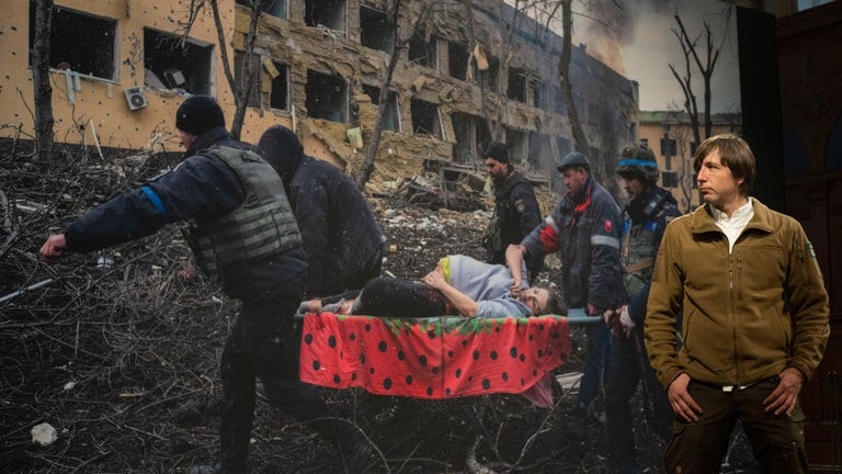 April 2023: Es ist das World Press Photo des Jahres von Evgeniy Maloletka, Associated Press (AP) - Fotograf und Gewinner des Preises.  Hier steht er vor seinem preisgekrönten Foto einer schwangeren Frau, die nach einem russischen Militärschlag in Mariupol (Ukraine) durch die Trümmer einer Entbindungsklinik getragen wird.