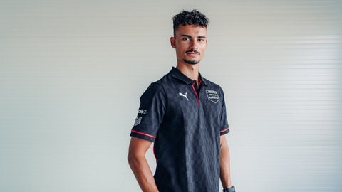 Pascal Wehrlein, Porsche-Werksfahrer, schaut in die Kamera. Pascal Wehrlein ist Weltmeister in der Formel E, war 2015 jüngster DTM Champion und ist zwei Jahre in der Formel 1 gefahren. Und er hat noch große Ziele: Er möchte die 24 Stunden in Le Mans fahren und gewinnen.