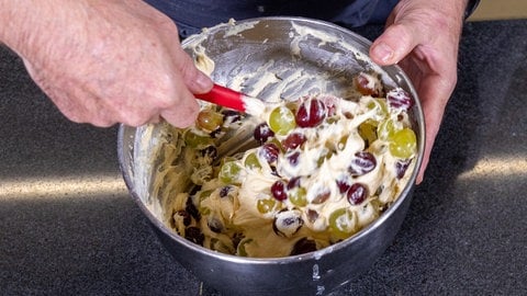 Für den Traubenkuchen die Weintrauben zum Schluss unter den Rührteig heben.