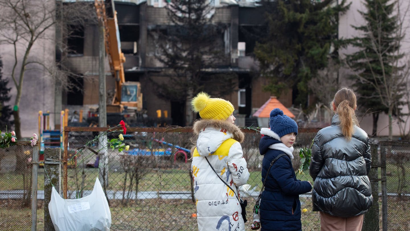Ukraine: Kinder betrachten einen ausgebrannten Kindergarten am Ort eines Hubschrauberabsturzes in der Stadt Browary bei Kiew.