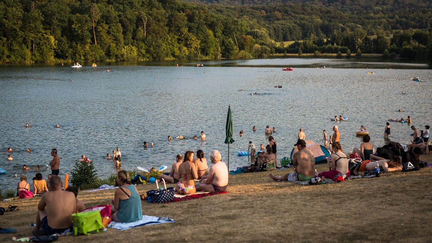 Menschen genießen einen sehr warmen Sommerabend am Badesee «Ehmetsklinge».