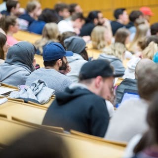 Studierende sitzen in einem Hörsaal in einer Vorlesung. 