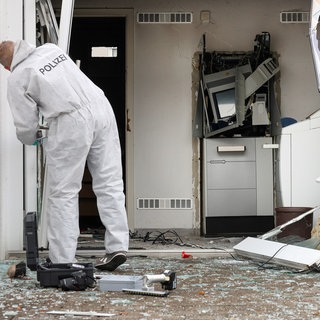 Ein Kriminaltechniker der Polizei sichert im Oktober 2023 an einem gesprengten Geldautomat in Riedlingen (Kreis Biberach) Spuren.