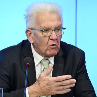 Winfried Kretschmann, Ministerpräsident von Baden-Württemberg, sitzt bei einer Pressekonferenz im Landtag und Antwortet auf Fragen von Journalisten