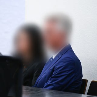 Der Inspekteur der Polizei (rechts) sitzt vor der Urteilsverkündung im Prozess im Juli 2023 mit seiner Frau im Gerichtssaal (Archivbild).