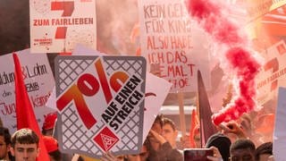 In Bayern nehmen Menschen mit Plakaten und Fahnen an einer Auftaktdemonstration der Tarifverhandlungen für die Metall- und Elektroindustrie teil. Die IG Metall fordert sieben Prozent mehr Lohn für Beschäftigte - die ersten Tarifverhandlungen starten heute in Baden-Württemberg, Bayern und Sachsen.