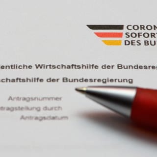 Ein Stift liegt auf einem Antrag auf Gewährung der "Novemberhilfe" als außerordentliche Wirtschaftshilfe der Bundesregierung in der Corona-Krise. Am Montag endet die Frist für die Schlussabrechnungen.