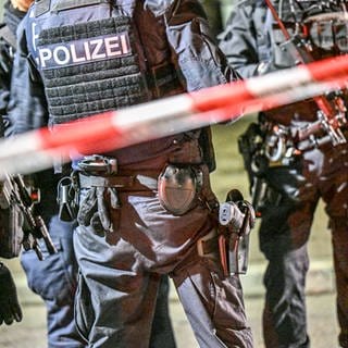 Polizei und ein Absperrband nach Schüssen in einer Bar in Göppingen.