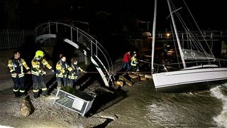 Bei schwerem Sturm versuchen Feuerwehr und THW in Wasserburg am Bodensee Boote zu sichern und ein Abtreiben zu verhindern