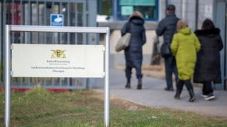 Geflüchtete betreten die Landeserstaufnahmestelle für Flüchtlinge (LEA) in Ellwangen. Das BW-Justizministerium möchte Kommunen mit solchen LEAs entlasten.