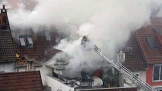 Dichter Qualm steigt bei einem Feuer in der Innenstadt von Esslingen auf. Nachdem Mietstreitigkeiten eskaliert sind, gab es zwei Tote und zwei Verletzte. Der Vater eines der Opfer erhebt schwere Vorwürfe gegen die Polizei.