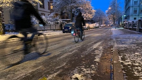 Fahrradfahrer auf einer vereisten Straße in Freiburg.