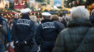 Polizeibeamte gehen über den Weihnachtsmarkt in Stuttgart.