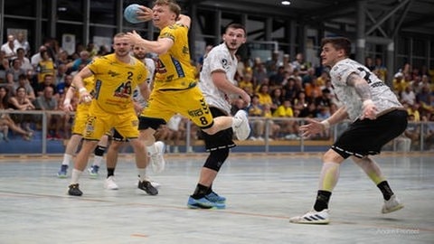 Handballer springt mit Handball in der Hand