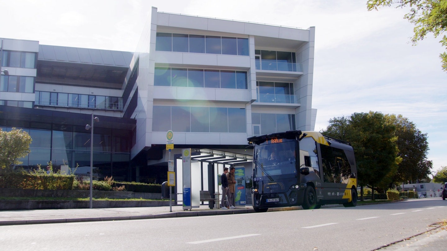 Gelb-schwarzer Kleinbus hält an Bushaltestelle vor ZF-Forum in Friedrichshafen