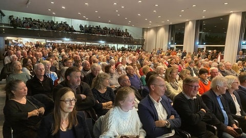 Menschen im Überlinger Kursaal bei der Vorstellungsrunde der sechs Kandidaten zur OB-Wahl.