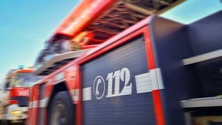 Zwei Einsatzfahrzeuge der Feuerwehr mit großer Aufschrift 112. Grafischer Effekt. Symbolbild