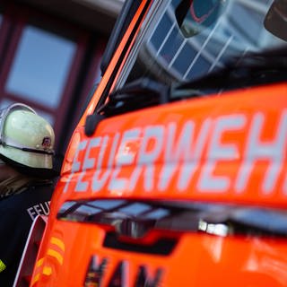 Symbolfoto: Feuerwehrfahrzeug und Feuerwehrmann.