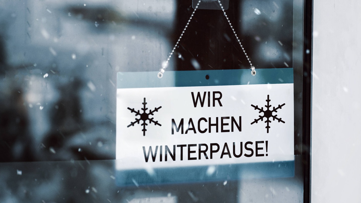 In einer Fensterscheibe hängt ein Schild mit der Aufschrift: 