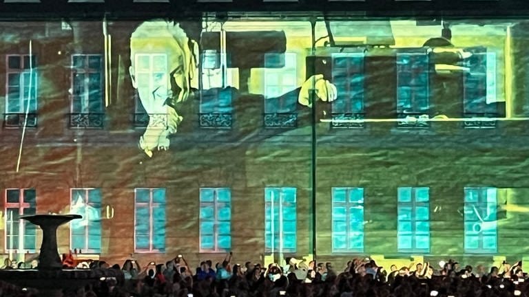 Das Gesicht von Herbert Grönemeyer wird beim Konzert auf die Fassade des Karlsruher Schlosses projiziert.