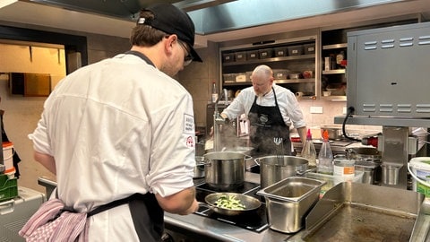 In der Küche des Landgasthofes "Zum Goldenen Anker" in Eggenstein-Leopoldshafen (Kreis Karlsruhe) stehen zwei Köche und kochen.