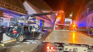 Ein schwer beschädigtes Auto, das nach einer Verfolgungsfahrt mit der Polizei in Pfinztal bei einem Unfall gegen eine Garage prallte.