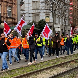 In Mannheim ziehen Mitarbeiter des Öffentlichen Dienstes bei einem Warnstreik mit Fahnen in einem Protestzug durch die Innenstadt.