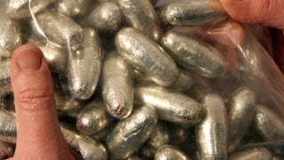 Sybolbild zeigt Drogen in Kondomen eingepackt.