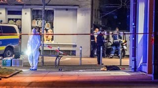 Polizeibeamte der Spurensicherung haben den Bereich um den Tatort an dem ein Mann in Stuttgart-Zuffenhausen angeschossen wurde abgesperrt.