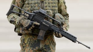 Ein Soldat in Tarnuniform mit einem Gewehr