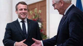 Bundespräsident Frank-Walter Steinmeier (r) begrüßt Emmanuel Macron, Präsident von Frankreich, im Schloss Bellevue.