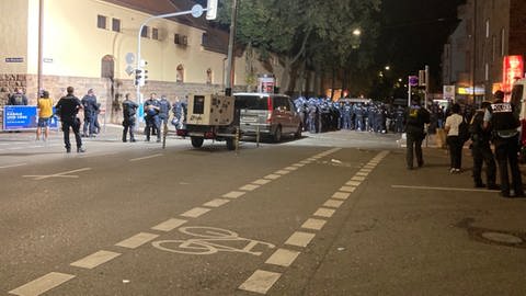 Viele Polizeibeamte stehen vor dem Römerkastell. Dort hatte es am Nachmittag Ausschreitungen bei einer Eritrea-Veranstaltung gegeben.