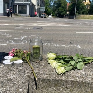 Blumen und Kerzen an der Stelle in Degerloch, an der ein Polizist einer Motorrad-Eskorte so schwer verletzt wurde, dass er kurz darauf starb.