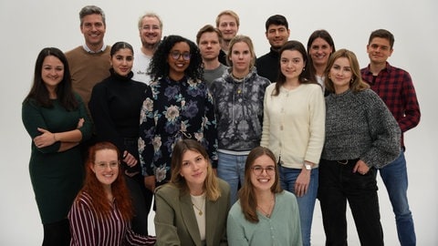 Mehrere Studentinnen und Studenten der Hochschule der Medien Stuttgart stehen nebeneinander, zusammen mit ihrem Professor Ingo Zamperoni.