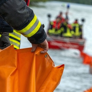 Sujetbild - Eine Ölsperre wird aufs Wasser gezogen. Auf dem Neckar breitet sich ein Ölfilm aus.