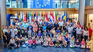 Kinder und Erwachsene posieren für ein Foto im Europäischen Parlament.