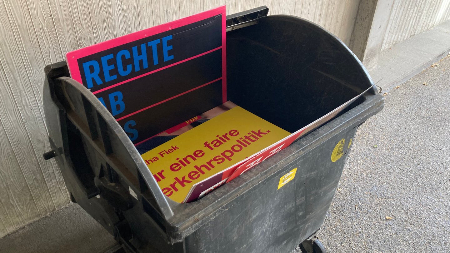 Wahlplakate in Mülltonne