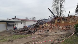 Letzte Löscharbeiten nach einem Gebäudebrand. Das Haus wurde vollständig zerstört.