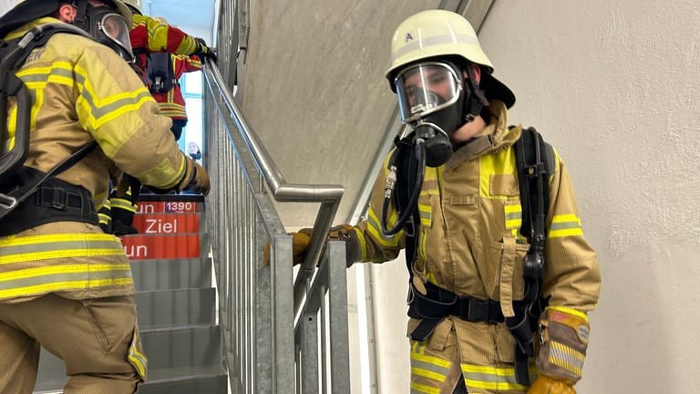 Bald geschafft: Zwei Feuerwehrleute im Treppenhaus des Rottweiler Testturms erreichen langsam das Ziel.