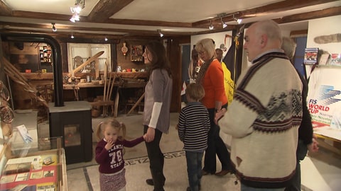 Walter Strohmeier, Enkel des Ski-Pioniers Ernst Köpfer, mit Besuchern im Skimuseum Bernau